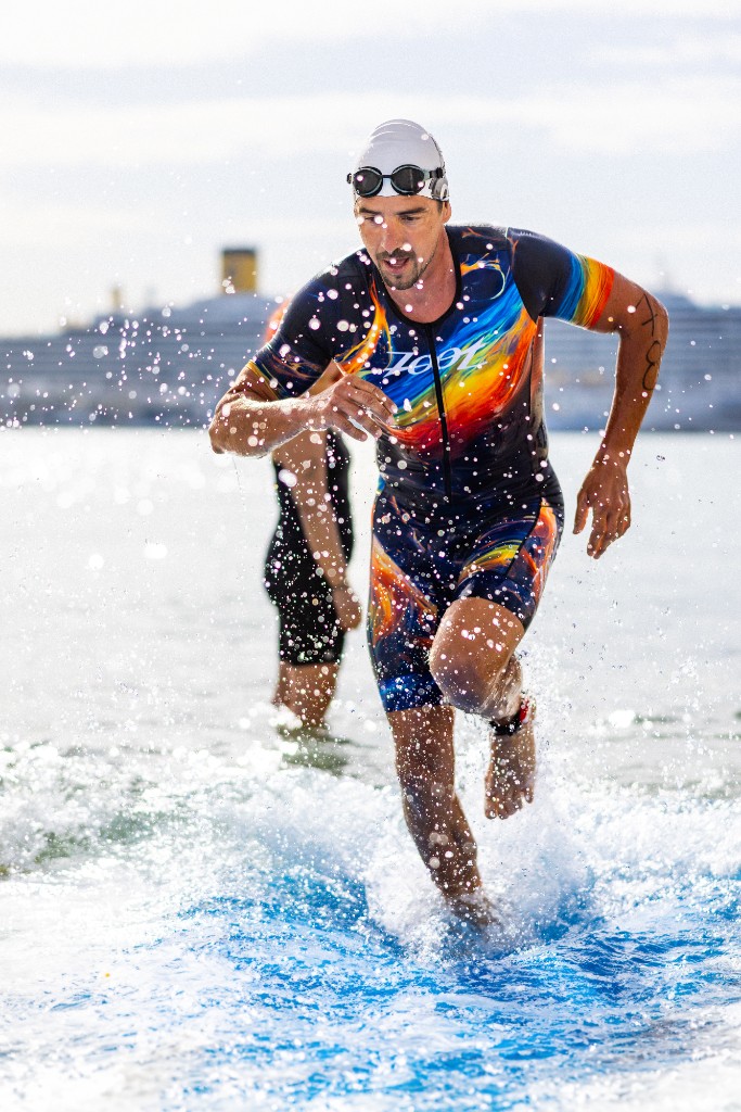 Triathlete running out of the sea during Split TRI