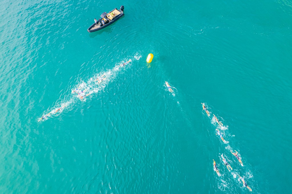 Open-water swim at Split TRI — athletes rounding a yellow buoy